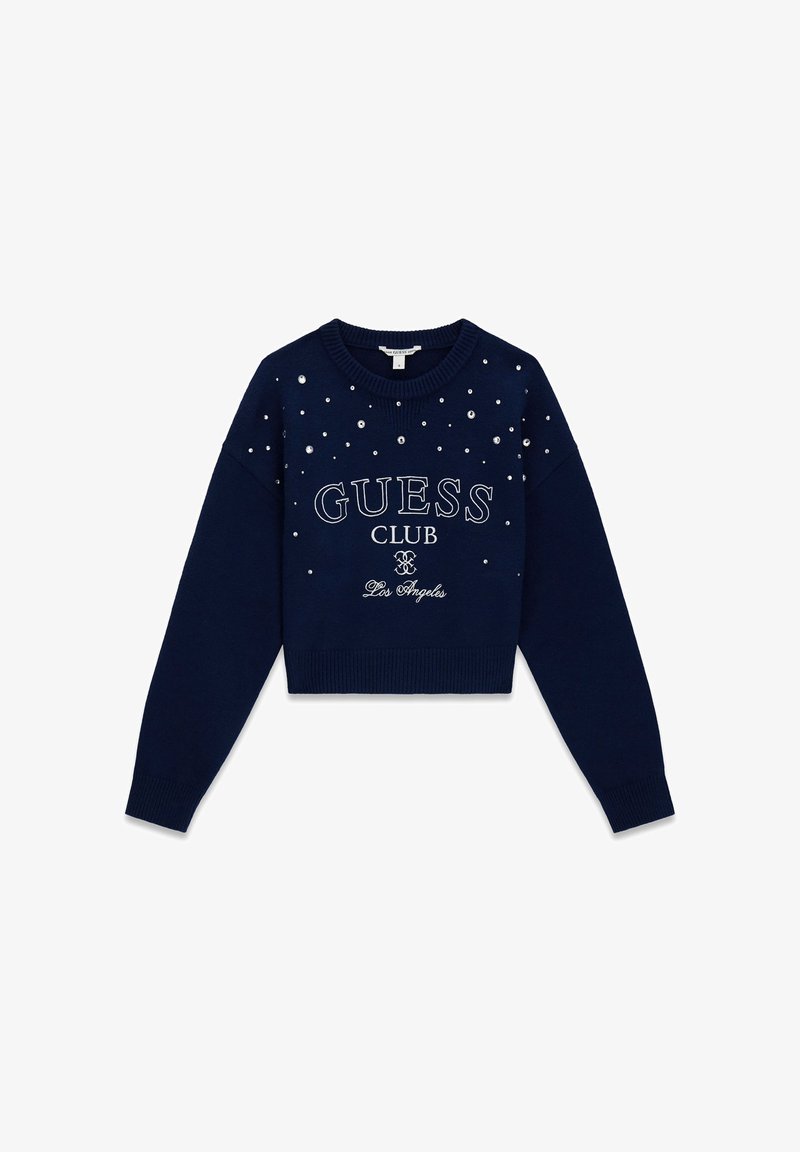 Pull court bleu marine avec col rond, orné de strass clairs dispersés. "GUESS CLUB Los Angeles" imprimé en blanc.