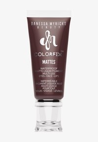 Danessa Myricks Beauty Colorfix Mattes, pigmento liquido opaco waterproof per occhi, viso e labbra, in una confezione marrone scuro con cappuccio trasparente.