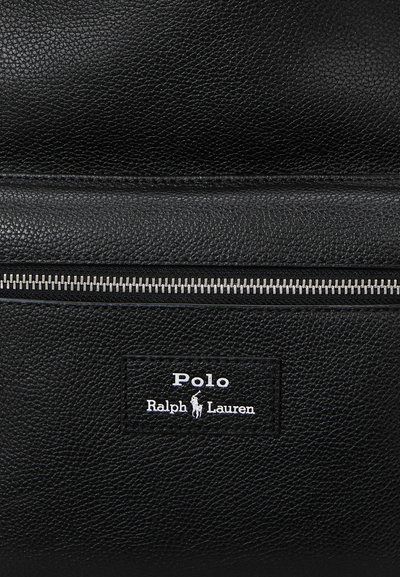 Black leather bag featuring a textured finish, silver zipper, and rectangular logo patch reading "Polo Ralph Lauren" in white.