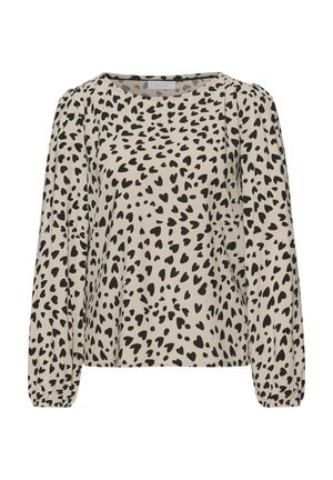 Beige long-sleeve blouse with black irregular heart-shaped spots and elastic cuffs, featuring a round neckline.