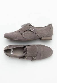 Gray suede shoes with two decorative straps and silver buckles, featuring contrast stitching and a low, stacked heel.