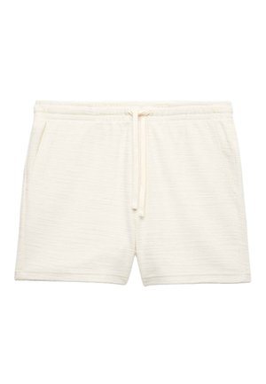Cream-colored textured fabric shorts with elastic waistband, drawstring tie, and side pockets.