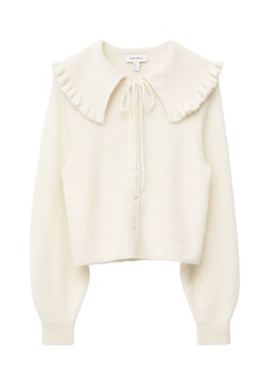 White knit cardigan with a ruffled collar, button front, and long sleeves. Soft texture with a cropped design and tie closure at neckline.