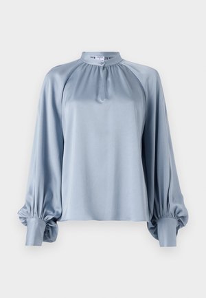 Light blue blouse featuring a high collar, long raglan sleeves with gathered cuffs, and a smooth, satin-like texture.