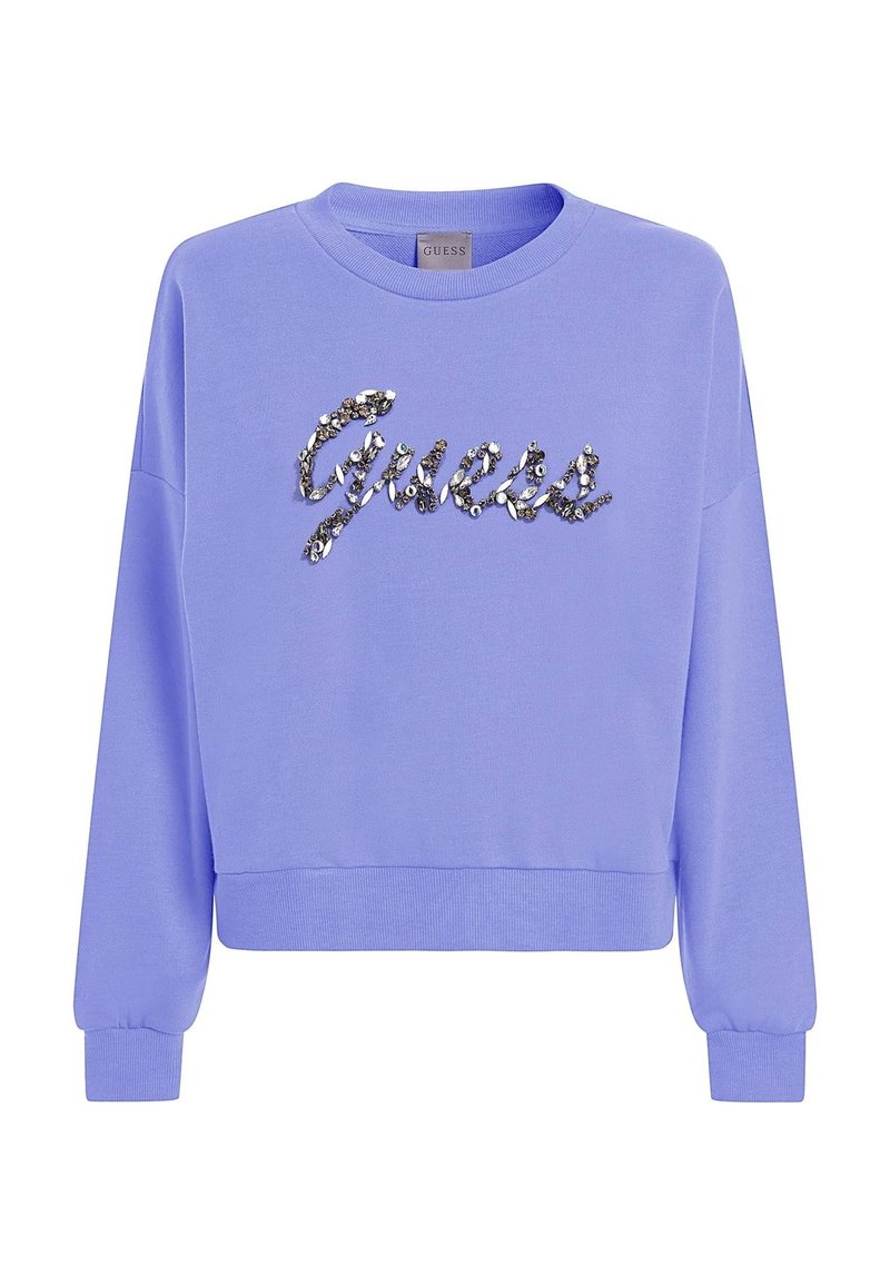 Felpa lavanda con collo a giro, maniche lunghe e polsini a costine. Logo "Guess" in paillettes scintillanti sulla parte anteriore. Tessuto morbido.