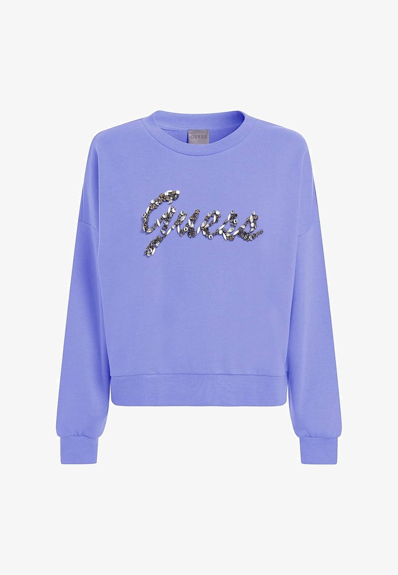 Felpa lavanda con collo a giro, maniche lunghe e polsini a costine. Logo "Guess" in paillettes scintillanti sulla parte anteriore. Tessuto morbido.