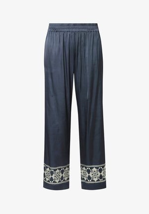 Donkerblauwe wijde broek met elastische tailleband en wit bloemmotief langs de zoom van beide pijpen.