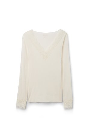 Long-sleeve cream blouse with V-neckline and lace trim on neckline and cuffs, displayed on a white background.