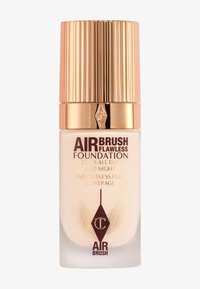 Airbrush Flawless Foundation in a clear glass bottle with a gold ribbed cap. Features embossed logo and printed claims in dark brown.