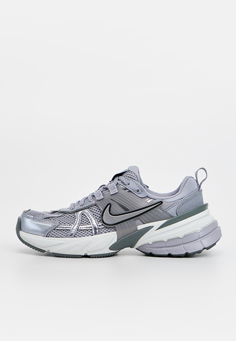 Scarpa da corsa grigia con upper in mesh, dettagli metallici, suola ammortizzata e logo swoosh nero lungo il lato.
