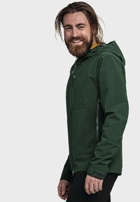 Green softshell jacket with a hood, featuring zippered pockets, a textured accent on the sleeve, and a smooth overall finish.