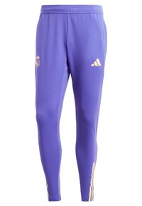 Purple athletic pants made of smooth fabric. Features a yellow team crest and three-stripe branding on the lower leg. Elastic waistband.