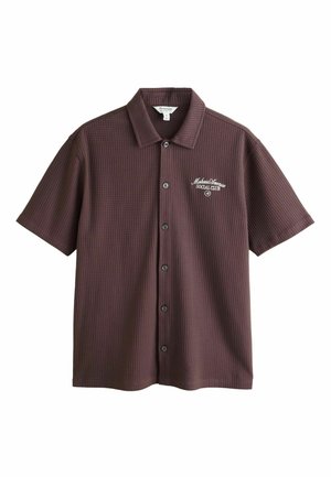 Short-sleeve dark brown button-up shirt with a textured pattern and white "Malibu Avenue Social Club" text on the left chest.