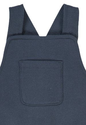 Marineblaue Baumwolloverall mit breiten Trägern, einer Fronttasche und stabilen Nähten. Der Stoff hat eine glatte Textur.