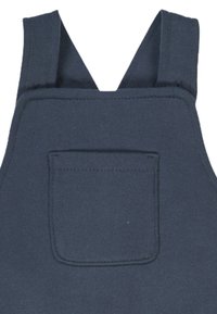 Navy blue cotton overalls feature wide shoulder straps, a front pocket, and sturdy stitching. The fabric has a smooth texture.