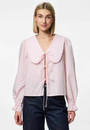 Light pink blouse with a large ruffled collar and tie front. Features long puff sleeves with elastic cuffs. Made of smooth fabric.