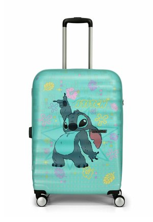 Valise rigide en teal avec un motif de Stitch de Lilo & Stitch. Présente des motifs tropicaux colorés et des roulettes doubles lisses pour une meilleure mobilité.