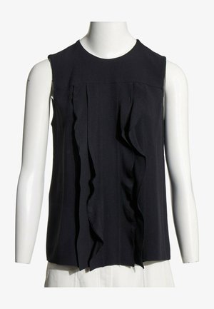 Blouse noire sans manches avec des détails de volants verticaux sur le devant, présentée sur un buste de mannequin blanc avec un fond blanc.