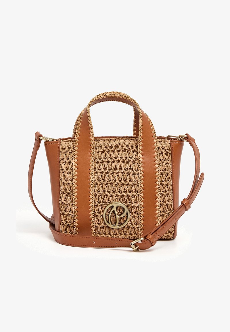 Woven straw handbag with brown leather accents, dual handles, and adjustable shoulder strap. Features a circular metallic logo on the front.