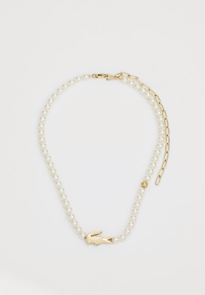 Collier de perles avec des accents dorés, présentant un fermoir en or et un charme animal doré décoratif. Perles lisses et rondes dans un motif uniforme.