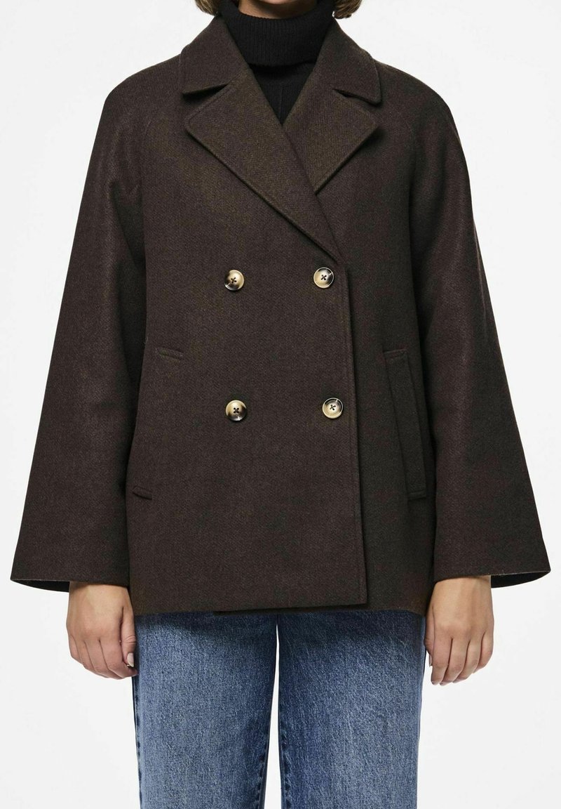 Brun dubbelknäppt kappa i en texturerad ullblandning, med gyllene knappar, slagkrage och sidofickor med vida ärmar.