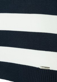 Navy blue and white striped sweater featuring a ribbed texture. Includes a silver tag labeled “Modar & Morsi" on the lower right.