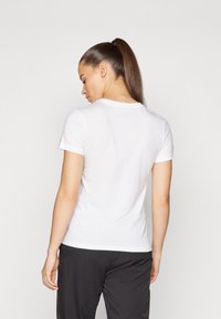 White short-sleeve t-shirt made of soft, smooth cotton. Features a classic crew neckline and a tailored fit without any visible embellishments.