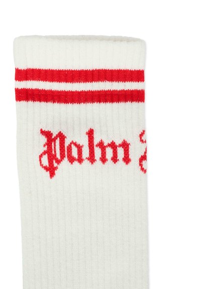 Calzino bianco con strisce rosse nella parte superiore e la scritta "Palm" in carattere gotico rosso. Presenta una texture a coste e un design atletico classico.