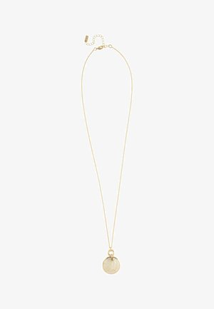 Delicate gold chain necklace with a round textured pendant featuring a leaf pattern and a small gold ring above it.