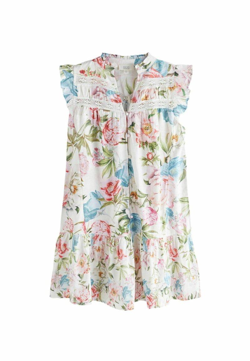 Robe blanche sans manches avec imprimé floral coloré, bordure en dentelle sur la poitrine, épaules volantées et jupe avec détails à volants superposés.