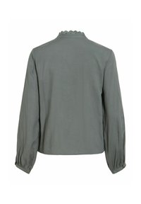 Blouse grise à manches longues avec un col orné de dentelle et des poignets boutonnés, vue de dos sur fond blanc.