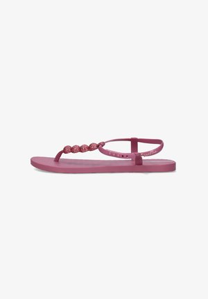 Sandalo basso rosa con decorazione di perline scintillanti sulla fascia delle dita e cinturino regolabile alla caviglia su sfondo bianco.