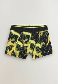 Boxers noirs ajustés avec un motif audacieux d'éclairs verts et jaunes, présentant une taille noire avec des rayures vertes et un design moulant.