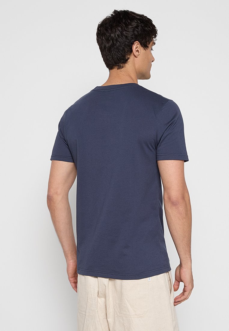 T-shirt di cotone blu navy con scollatura rotonda e maniche corte, caratterizzato da una texture liscia e un design a taglio dritto.
