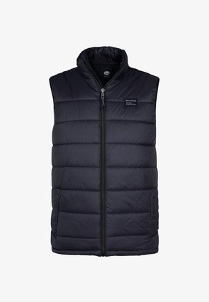 Marineblå puffervest med høj krave, frontlynlås og sidelommer. Har quiltede sektioner til isolering og varme.