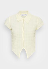 Camisa de manga curta, amarela pálida, com um padrão de xadrez texturizado, colarinho pontudo e um fecho frontal com botões, apresentando uma bainha dividida.
