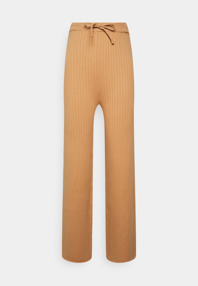Calças largas com efeito canelado na cor bege, com uma cintura ajustável por cordão. Tecido suave com uma superfície texturizada e bainha reta.