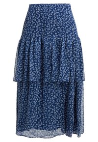 Vícevrstvová dlouhá sukně z námořnického modrého materiálu, zdobená jemným bílým květinovým vzorem. Lehounká, polopropustná, s volánovými vrstvami pro zvýšení textury.