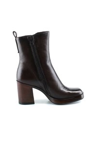 Bottine en cuir marron foncé avec fermeture éclair latérale et talon bloc empilé sur fond blanc.