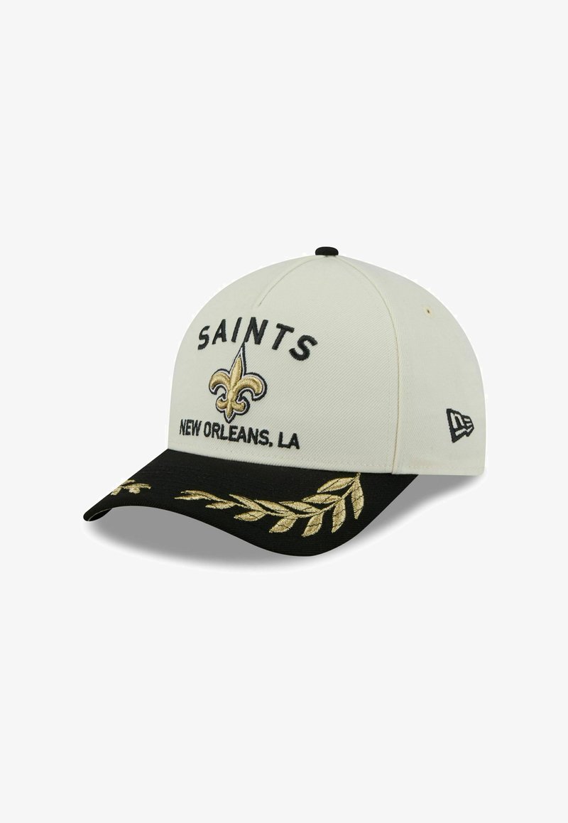 Cap features a white fabric body with a black visor. Embroidered "SAINTS" and a gold fleur-de-lis logo on the front. Gold leaf accents.