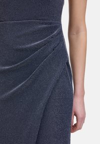 Marineblaues, drapiertes Kleid aus strukturiertem Stoff, mit einer gefältelten Detail am Bund, glatter Oberfläche und taillierter Silhouette.