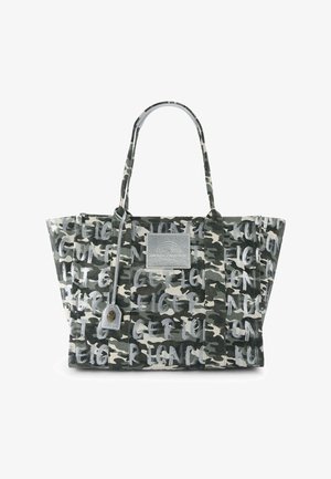 Camouflage-pattern tote bag with black, white, and gray tones, featuring graffiti-style text and a silver rectangular patch on the front.