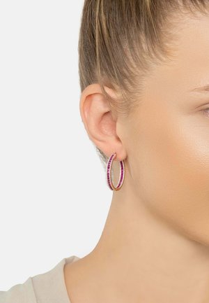 Gold hoop earrings featuring alternating pink and white stones, showcasing a smooth finish and circular design.