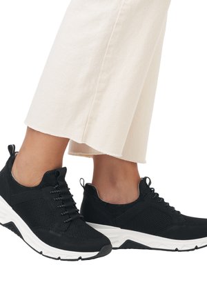 Black athletic shoes with mesh and solid fabric, featuring white soles, laces, and a pull tab at the heel for easy wear.