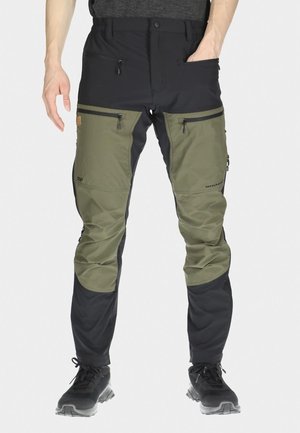 Men's outdoor pants in olive green and black, made from durable fabric. Features zippered pockets and reinforced areas for added functionality.