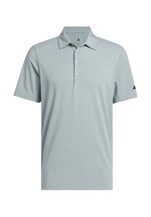 Light gray short-sleeve polo shirt with subtle circular pattern, three-button placket, and black Adidas logo on left sleeve.