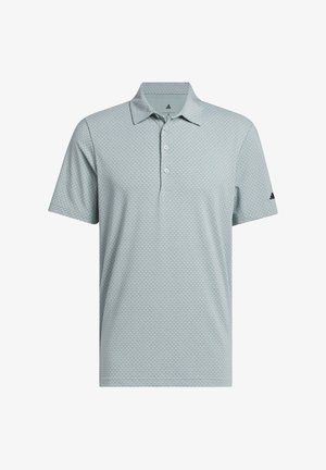 Light gray short-sleeve polo shirt with subtle circular pattern, three-button placket, and black Adidas logo on left sleeve.