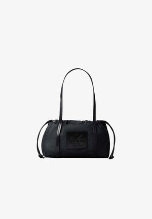 Sac d’épaule en nylon noir avec longues sangles, côtés à cordon, et un patch avant embossé du logo Calvin Klein.