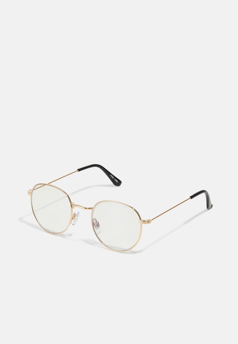 Golden metal eyeglasses with oval frames and transparent lenses. Features black ear tips and adjustable nose pads for comfort.