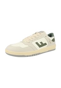 Sneakers with a beige suede and cream leather upper, green accent logo, cream laces, and a grey rubber sole featuring vertical grooves.